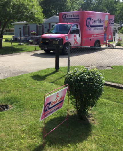 Great Lakes Heating & Air Conditioning yard sign in a yard with the truck in the driveway